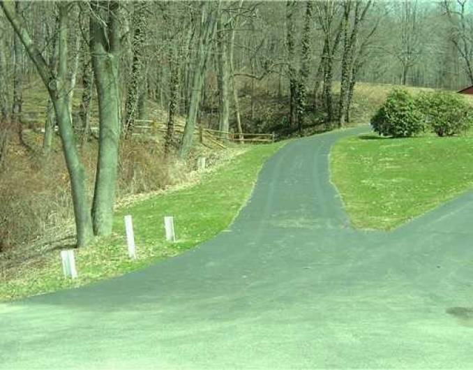 Paved Right of Way to left up the hill.  Properties' 20' frontage is between the two homes to the right.