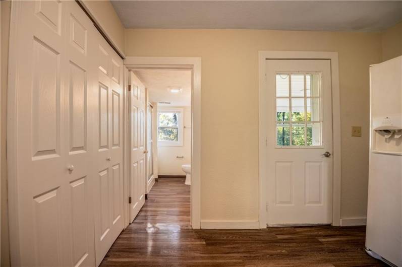 Kitchen to Full Bath View, Laundry area behind doors on left