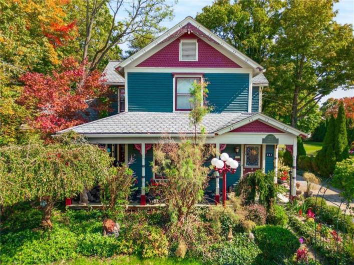 Inviting wrap around porch, lush landscaping