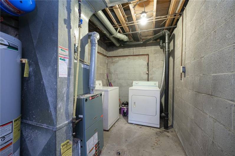 Utility and laundry room down stairs next to the garage.