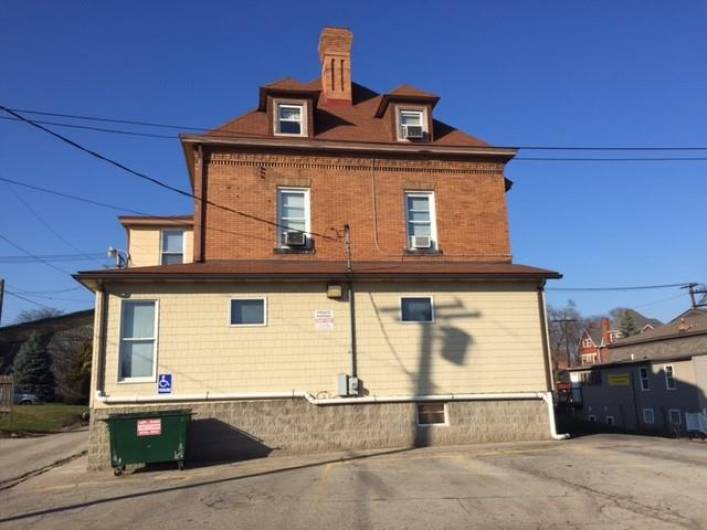 Rear Addition with Parking. This addition wraps around the side of the building, where there is an additional third exterior entrance