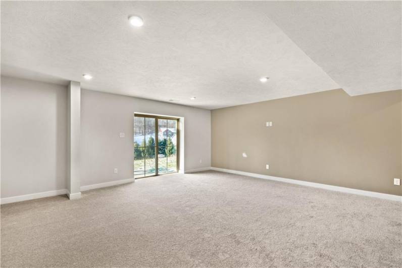 Prepare to be in awe of this special finished game room with custom accent wall.