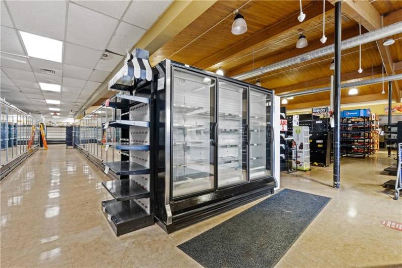 Multiple freezers, display cases and shelving