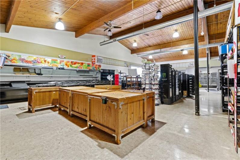 Front of store meat display cases and wood display tables