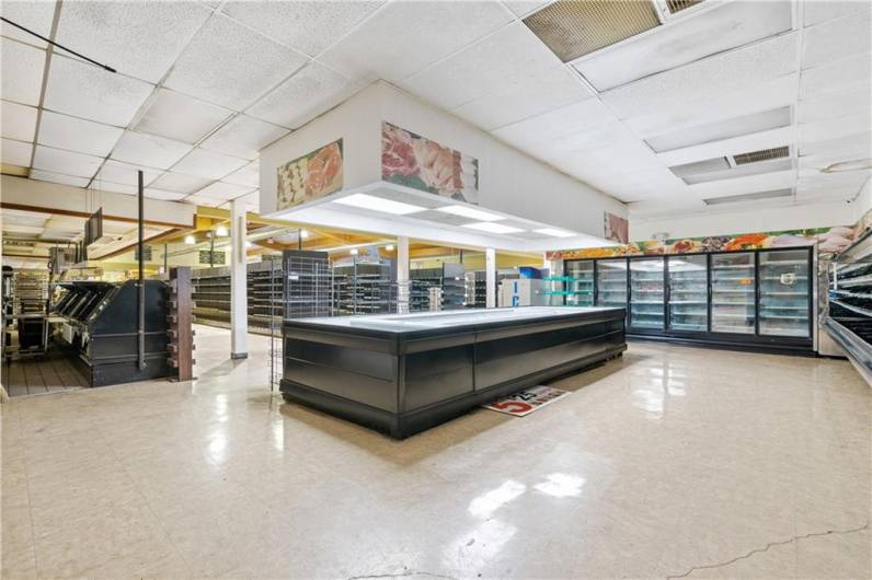 Produce area facing towards front of store.  Deli counter and display to the left