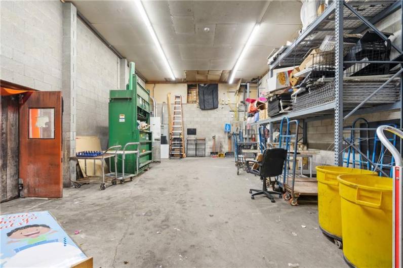 Back storage, walk in freezer and unloading area for trucks at parking lot level