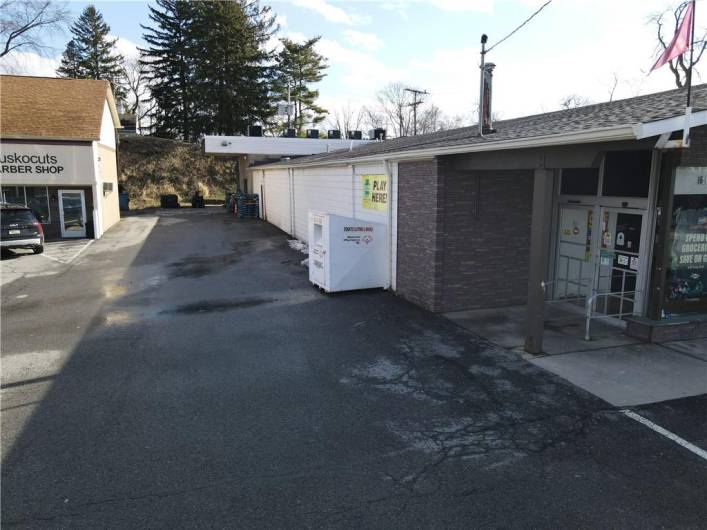 Entrance and driveway to parking lot level loading area on left side of bldg