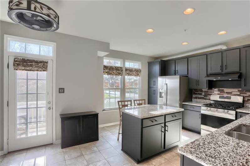 The kitchen boats a French door that leads to the rear deck with a gas line for your grill.