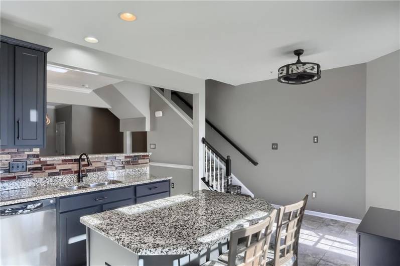 A modern fandelier graces the kitchen area before heading upstairs.