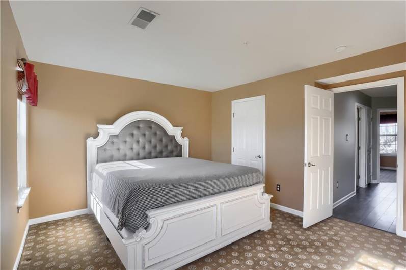 Retreat to the sizable primary bedroom with a walk in closet and spa like bathroom.