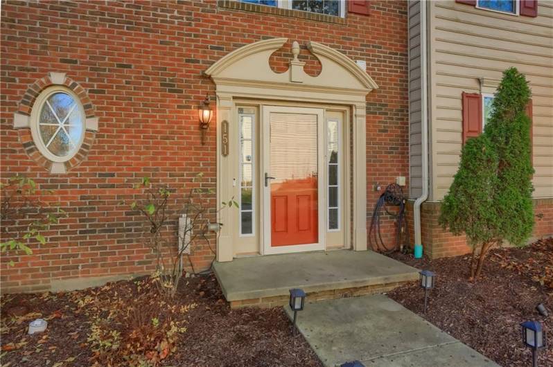 A quaint front stoop greets guests into the spacious home.