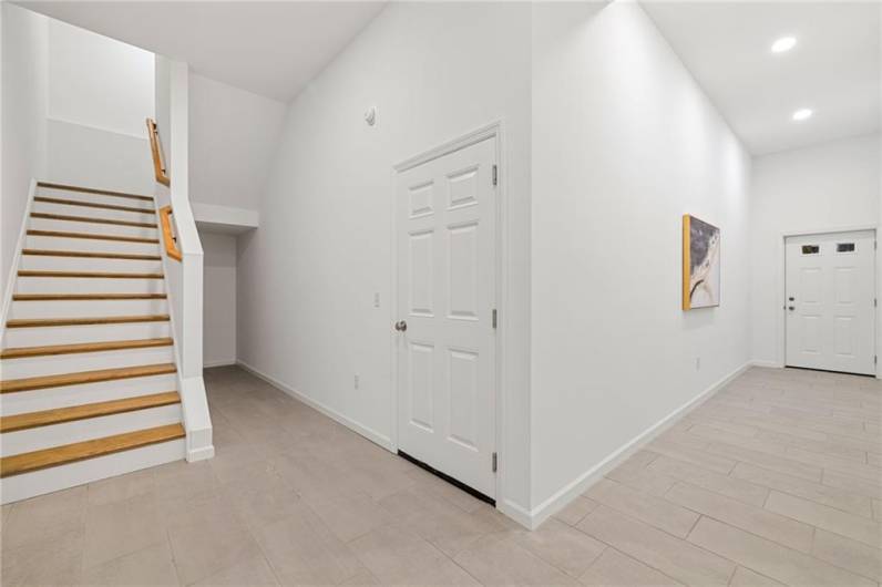 The entry features a wide stairwell to the upper floor!