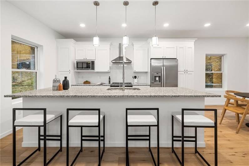 The kitchen has an oversized eat-in island and bright cabinetry!