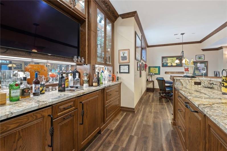 Back bar area with shelving, mirrors and display area- two pull out bottle drawers on each side of TV!