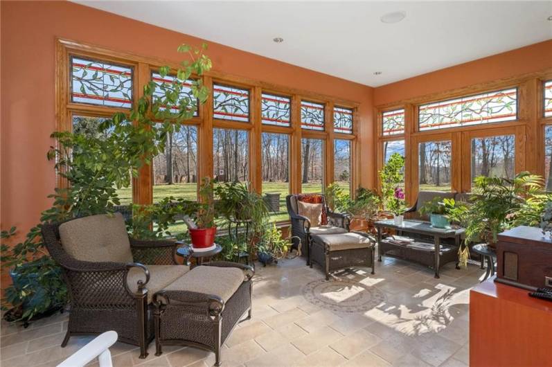 Sunroom/Solarium open to a covered deck on the side of home!