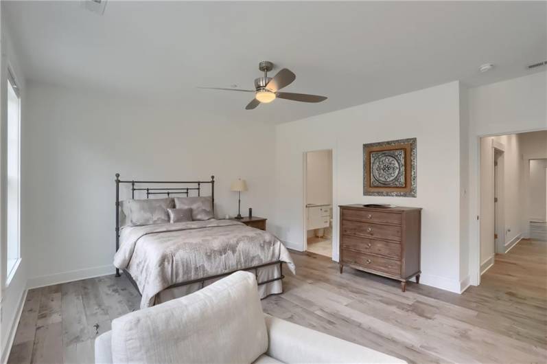 Settle into the guest ensuite bedroom boasting gorgeous hardwood flooring, neutral tone and luminous windows.