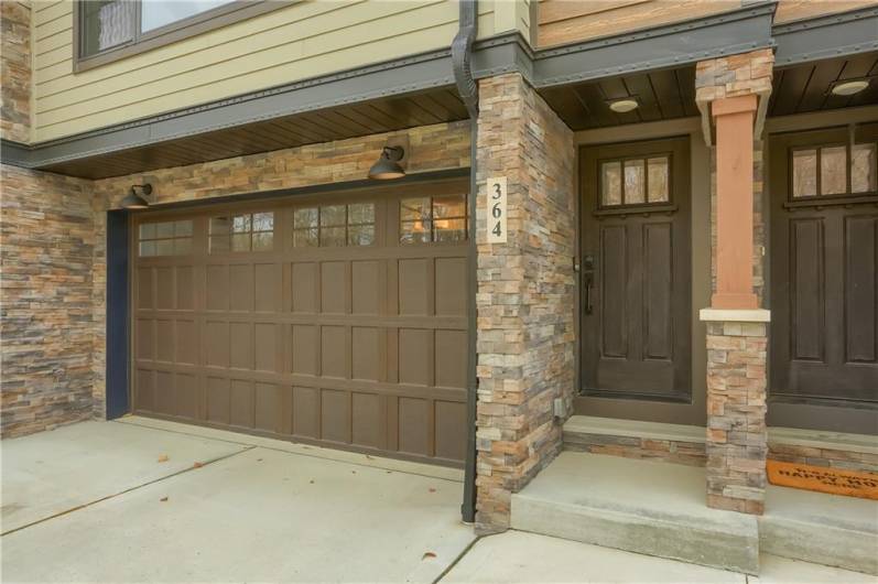 Stone accents the entrance of this townhome and complements the earth tones.