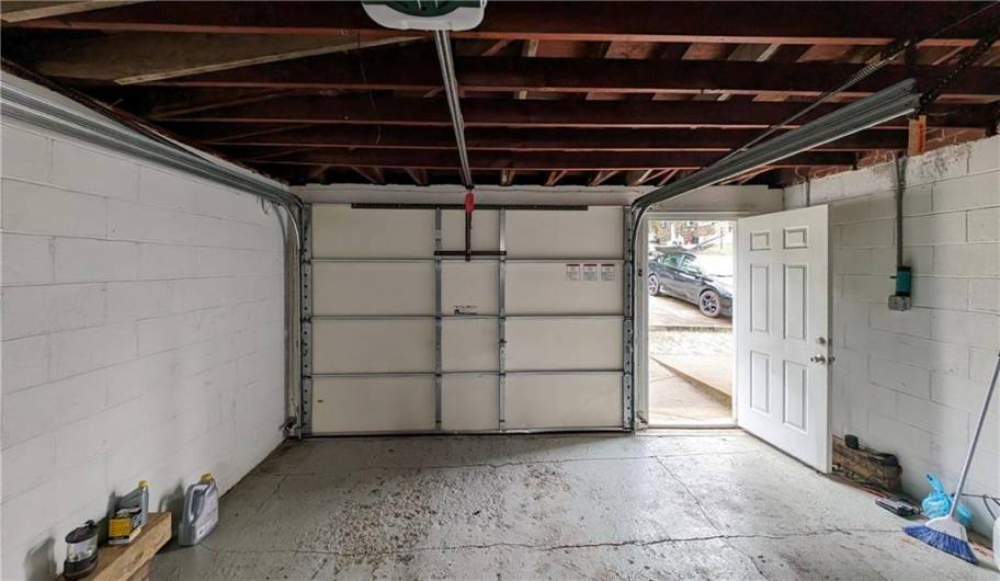 Clean first floor level attached garage with newer opener