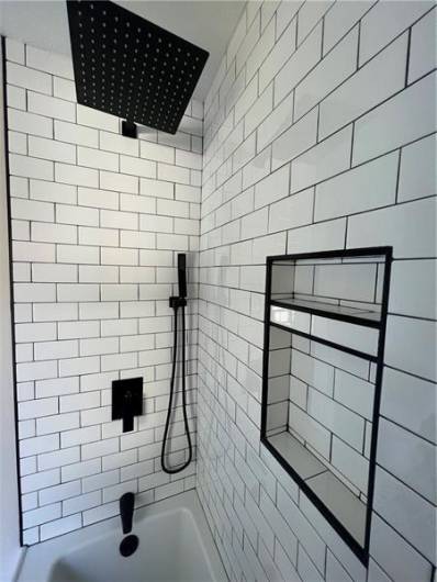 This shower is just gorgeous. The black fixtures are stunning.