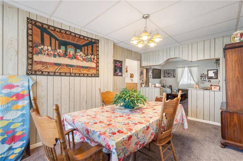 Another view of the formal dining room with updated lighting and carpet.