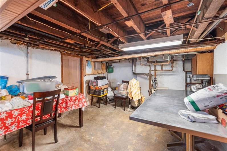 Additional room in the lower level would make a great workspace for preparing food, crafting, & More! There is a cold cellar currently being utilized for food storage.