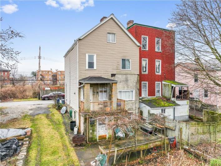 Walk out basement to the back of home with grape vine.