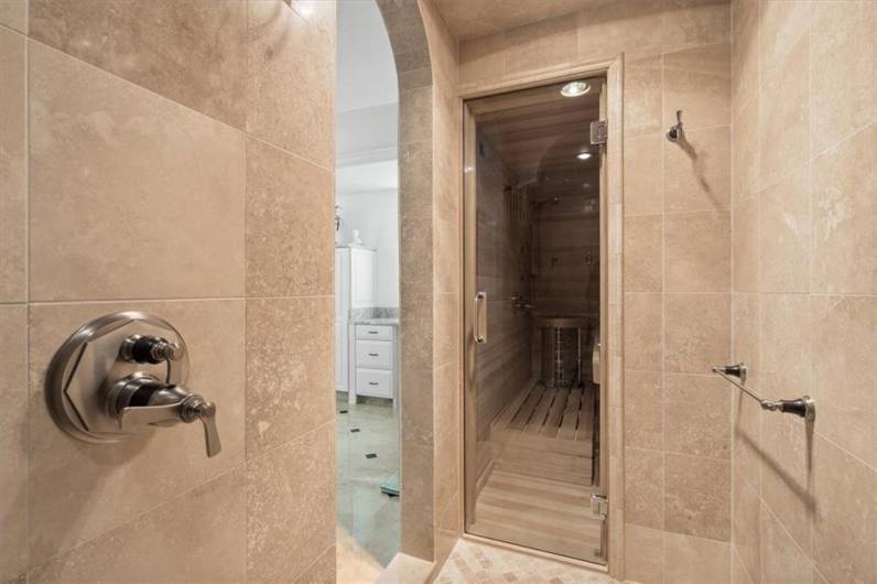 Expansive sauna opens to the luxurious tile shower.