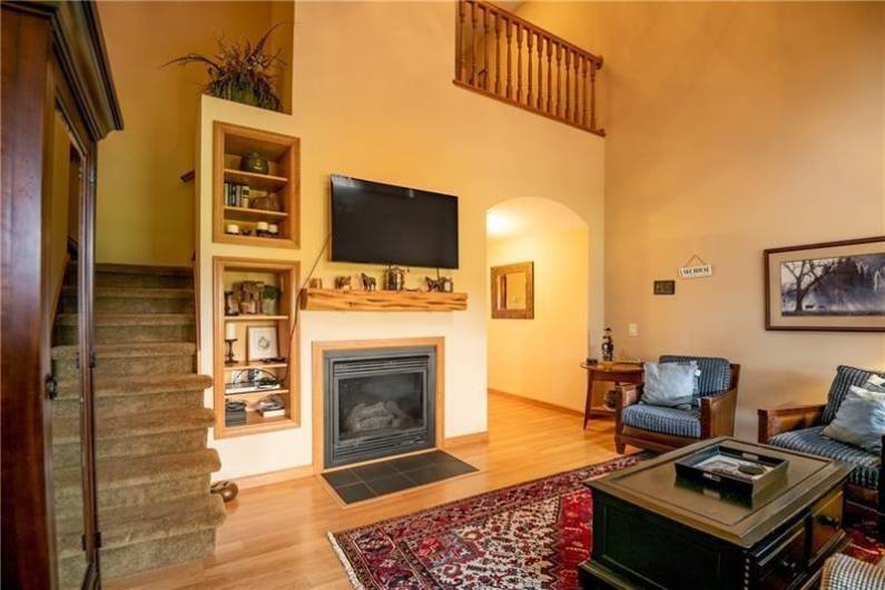 Vaulted ceiling, fireplace, & back porch off of the great room