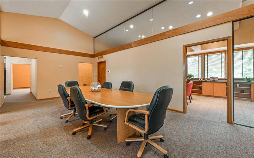 The Angled Ceiling is accented by the Glass Panels above the Crown Molding creating well lit Space throughout