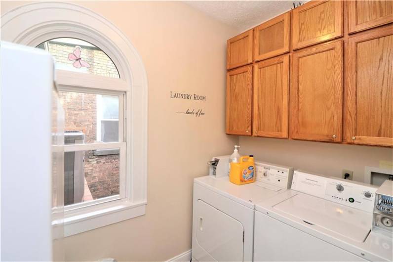 2nd floor laundry room for guest usage with refriigerator.