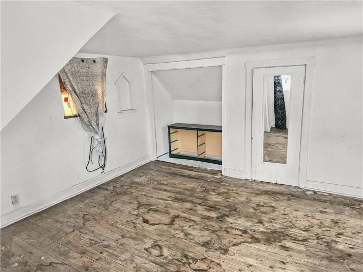 Large 3rd Floor bedroom w/original wood floors, large closet space, and excellent natural light!