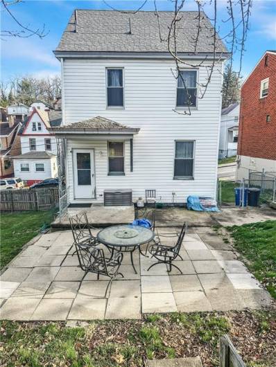 Rear Living space includes small rear porch, large patio, and huge beautiful, fully enclosed greensapce backyard w/firepit and cherry blossom tree!