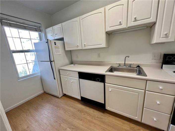 Clean white kitchen with plenty of cabinets and countertop space