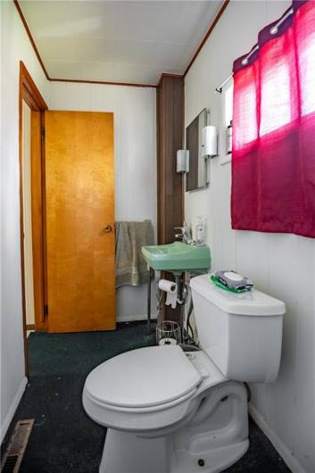 First floor powder room with large closet for additional storage.