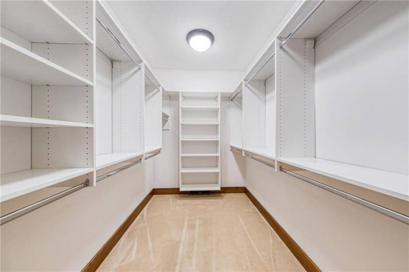 Primary bedroom closet organized for maximum utility.