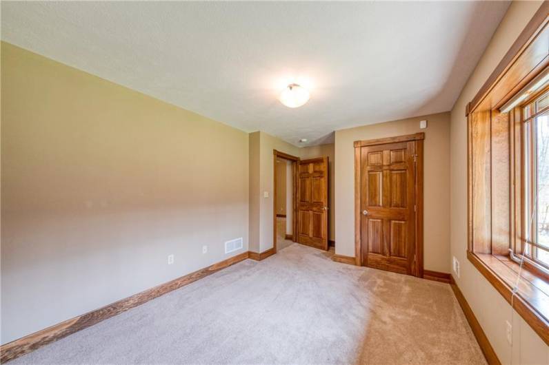 Fourth bedroom with lovely woodwork around the window and doors.