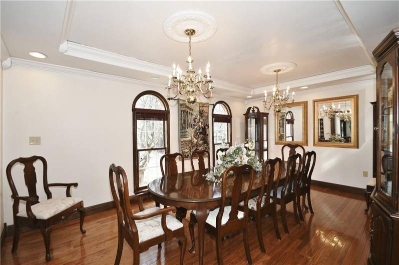 Beautiful Formal Dining Room with Gleaming Hard Wood Floors, Tray Ceiling and Lots of Natural Lighting