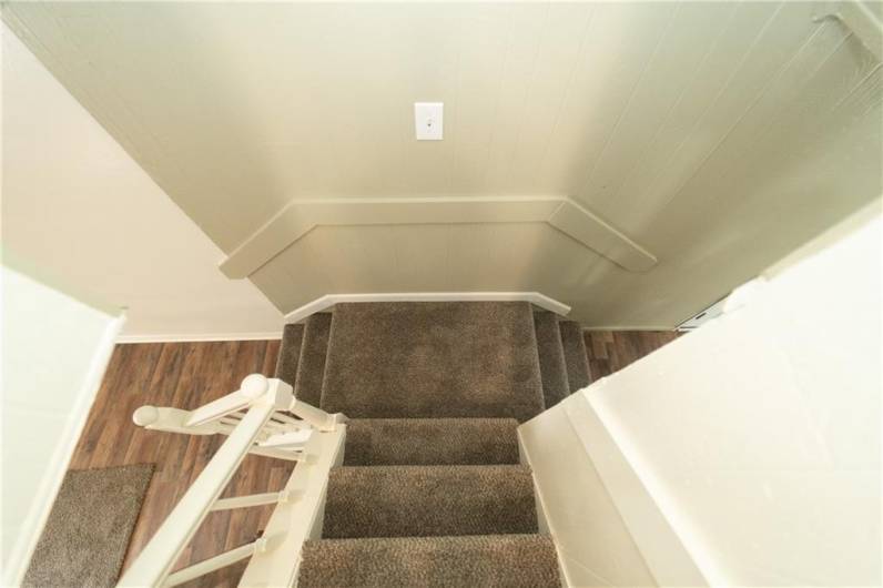 Double entrance staircase into living or dining room from upper level