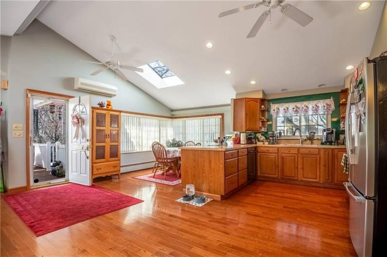 A light-flooded eat-in kitchen that leads out to the covered patio. Beautiful hard wood floors!!