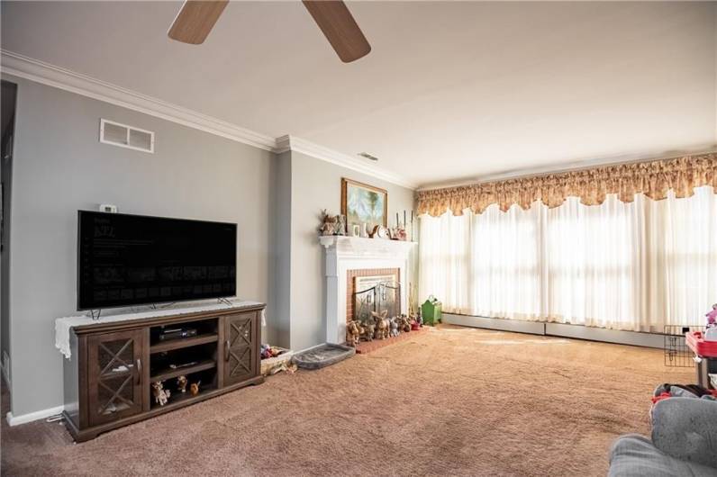 Lots of natural light fills this massive living room. One of the two handcrafted fireplaces that are found in this stately home.