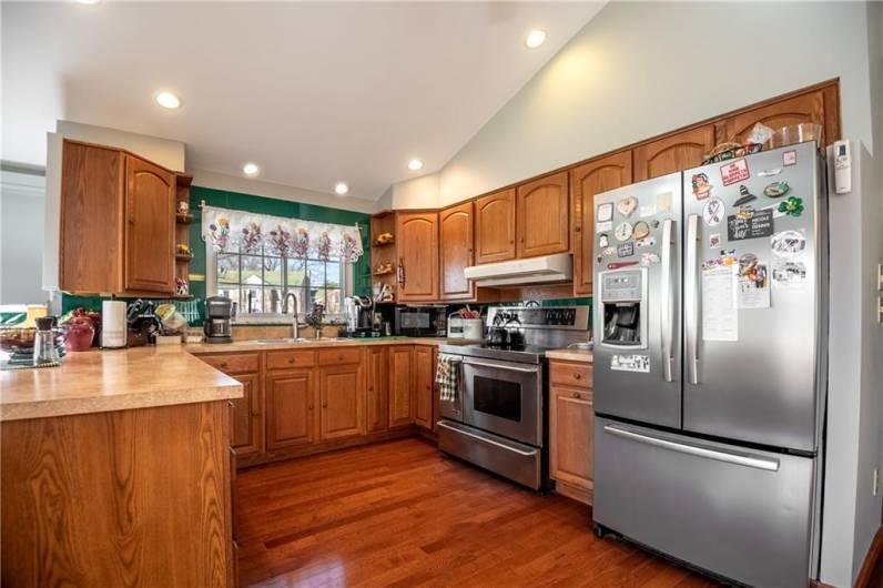 A wonderfully designed kitchen with a high end stainless steel appliance package. An oversized cooktop and oven for the chef in the house!