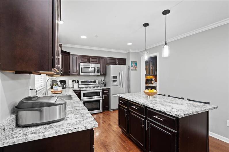 Stunning granite countertops and beautiful pendant lighting make this kitchen sparkle!