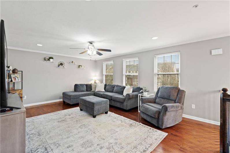 Spacious living room with three large windows that let in abundant natural light!