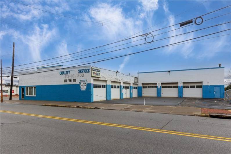 This building is over 6600 square feet and features (seven) 10 foot high Garage doors and parking lot.