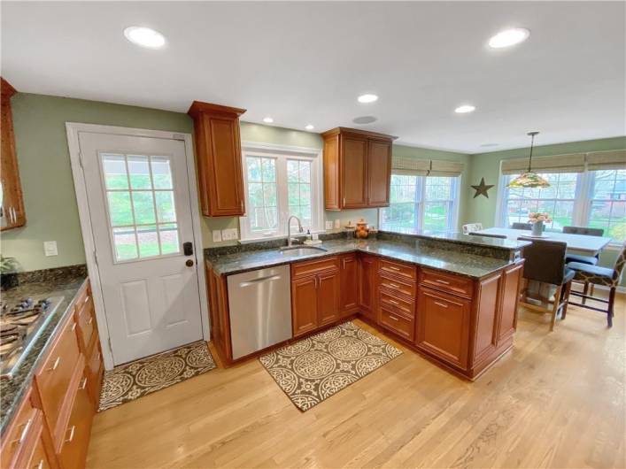 Granite countertops and recessed lighting complement the kitchen.