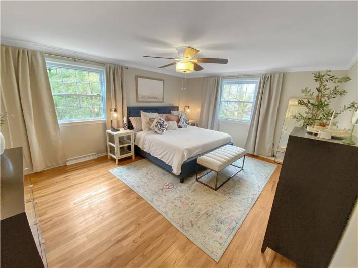 The master bedroom is accented with crown moldings and hardwood flooring.