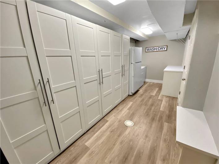 Nicely finished laundry with built-in storage cabinets.