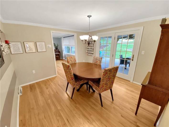 The dining room also features crown moldings and hardwood floors.  There is a French door leading to the rear patio.