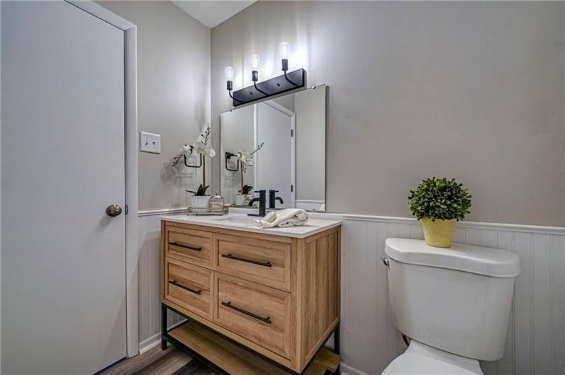 Stylish vanity and fixtures are highlighted in the guest bath.