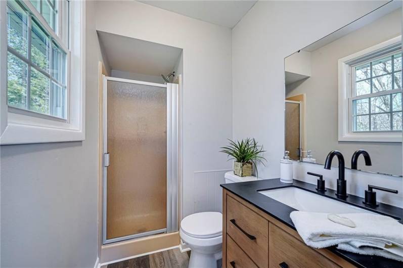 Primary en-suite with new shower door, flooring, paint, toilet and vanity!